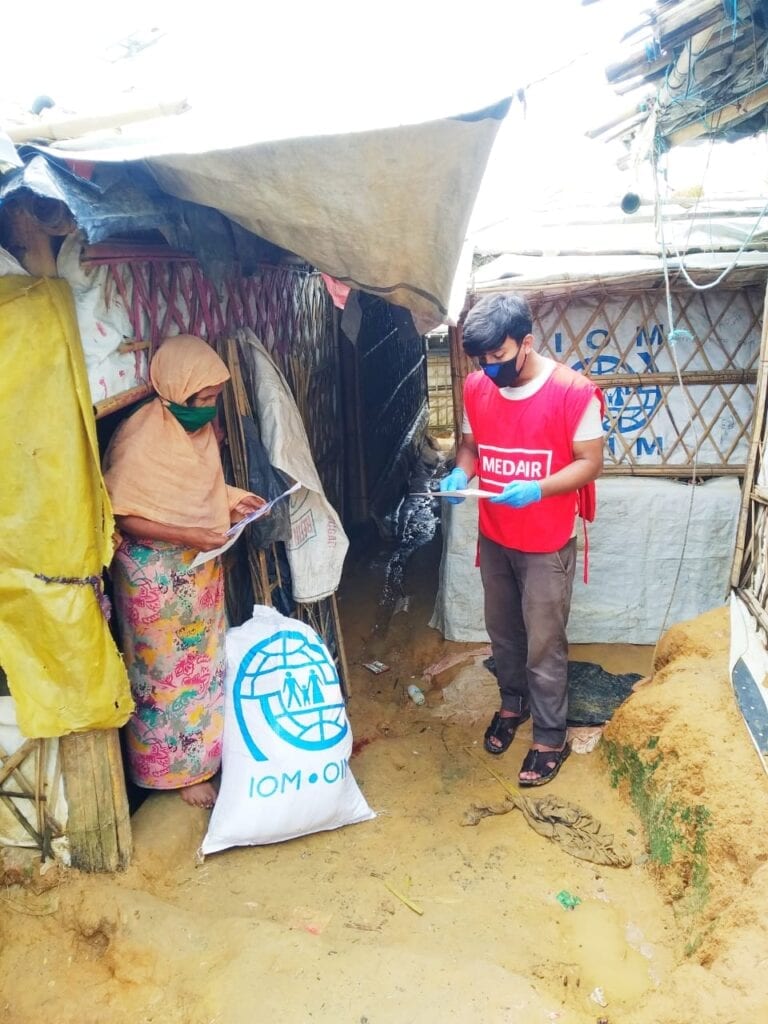 Hasan, Medair volunteer, shares information on items being given to a Rohingya family. © Medair