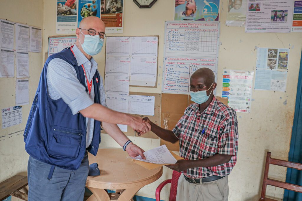 Medair CEO David Verboom accepts a hand-written letter from the leader of a community in Ituri Province, DR Congo.