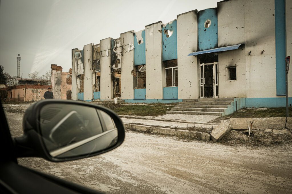 Affected by the conflict community members of Trostianets, Ukraine walking near destroyed railway station