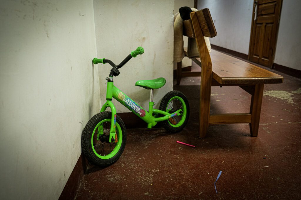 The bicycle is parked in the basement of church
