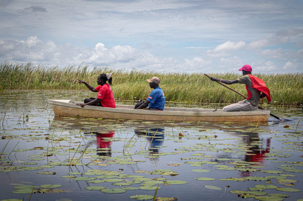 Humanitarian aid workers in a canoe in the swamp of South Sudan