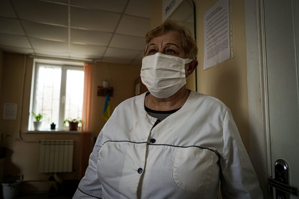 Une infirmière se tient à l'intérieur d'une clinique de santé.