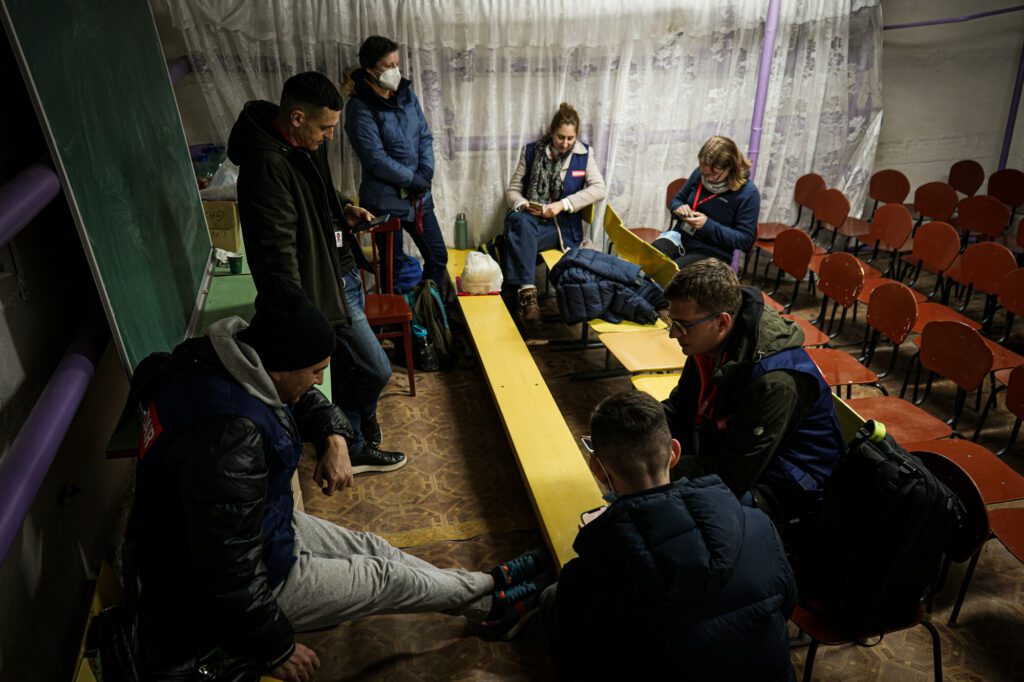 A humanitarian team sits underground inside a bunker in Ukraine.
