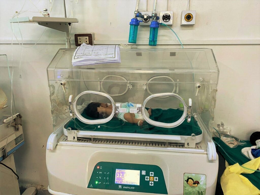 A one-day-old baby sleeps in an incubator in Deir ez Zor Hospital.