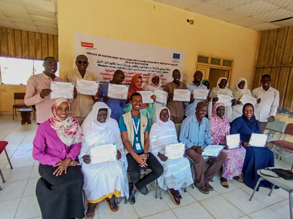 Participants of a Infection Prevention and Control Training in Blue Nile, Sudan, proudly show their certficates for successful participation.