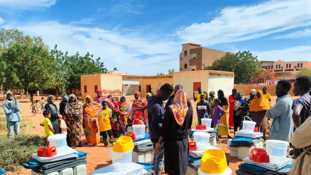 Humanitarian aid workers distribute household good to families affected by fighting in Khartoum.